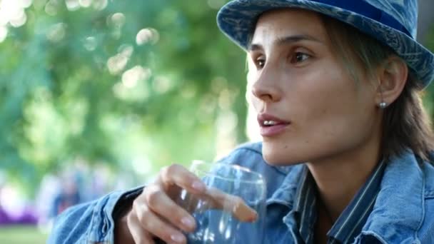 Hipster woman in hat smiling while drinking wine in foothills — Stock Video