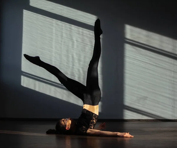 A young girl is doing stretching in the dance hall. — Stock Photo, Image