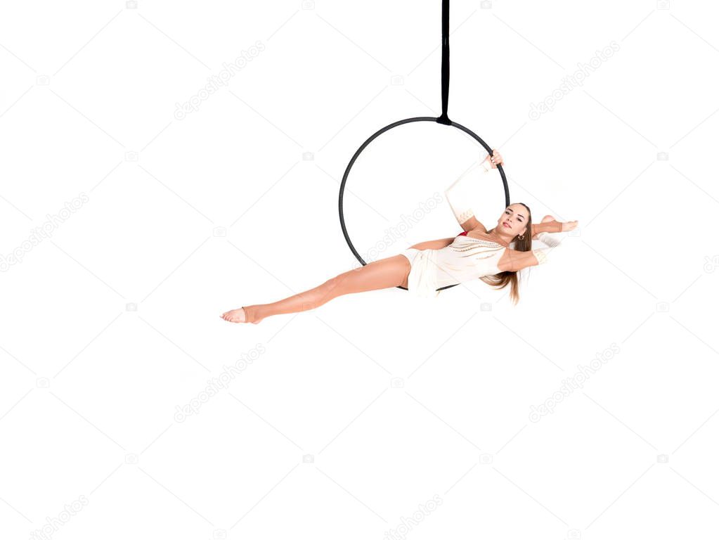 Young girl posing in an airy ring on a white background