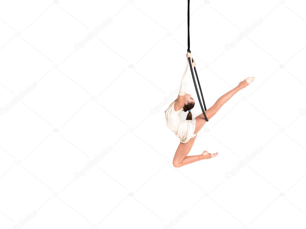 Young girl posing in an airy ring on a white background