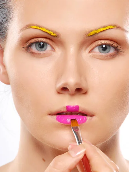 Young woman putting some special effects makeup on face — Stock Photo, Image