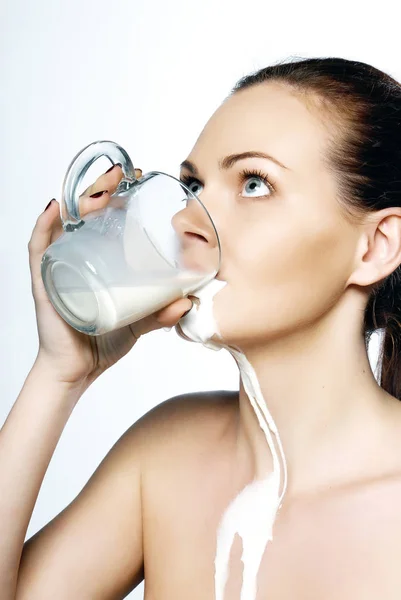 Portrait of a young woman with drops of milk on her — Stock Photo, Image