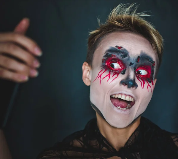 A girl makes selfie in makeup for Halloween. — Stock Photo, Image