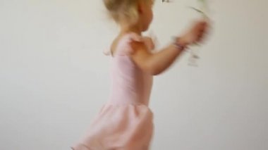 Küçük balerin beyaz bir arka plan üzerinde dans