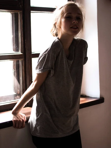 Young beautiful girl near the window. Light picture. — Stock Photo, Image