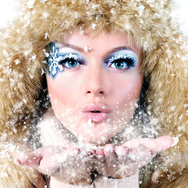 Kauneus talvi tyttö puhaltaa lunta pakkasessa talvella — kuvapankkivalokuva