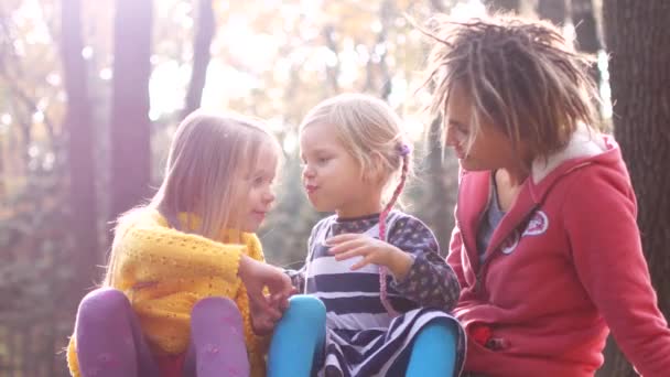 Mamá con niñas en un picnic en el bosque de otoño — Vídeos de Stock