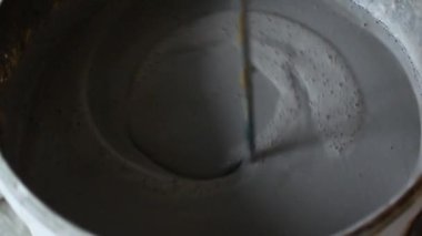 Çimento, işçi karışımları gevşek malzeme ve çimento üretmek için su bir kova atış kapatın