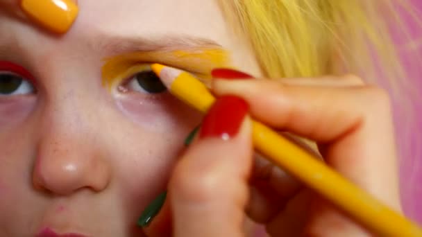 Liten blondin gör makeup. Ljusa mode video — Stockvideo