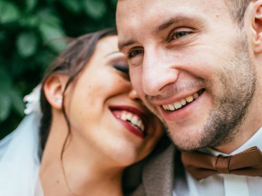 Evdeki düğün çifti birbirine sarılıyor. Beyaz elbiseli güzel bir kız. Takım elbiseli adam. Damat ile güzel gelin.