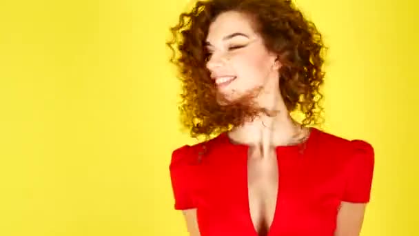 Beautiful young woman in red dress jumps. Curly hair flying up and down. 4k. — Stock Video