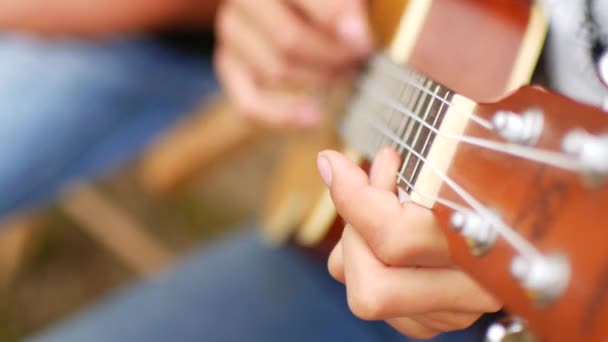 Child plays the guitar, ukulele. Close-up — Stock Video