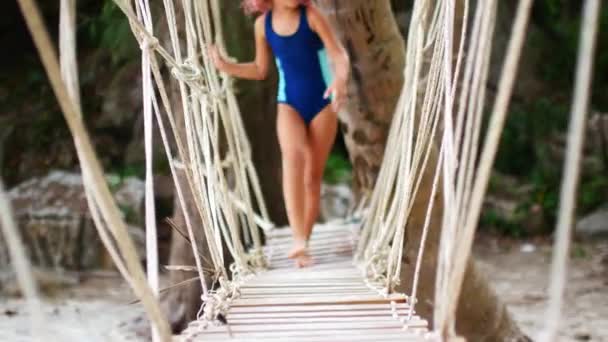 Óvodás lány tornázik a strandon. — Stock videók