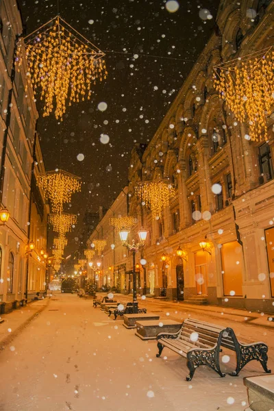 Moscow street decorated with an arch of illumination and lights for New Year and Christmas holidays.