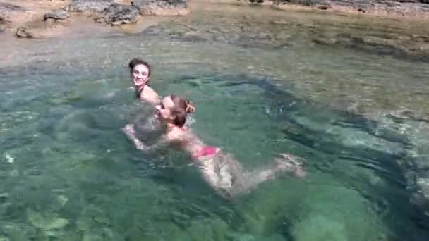 Två Unga Kvinnor Bikini Plaskar Och Leker Vatten Havet — Stockvideo