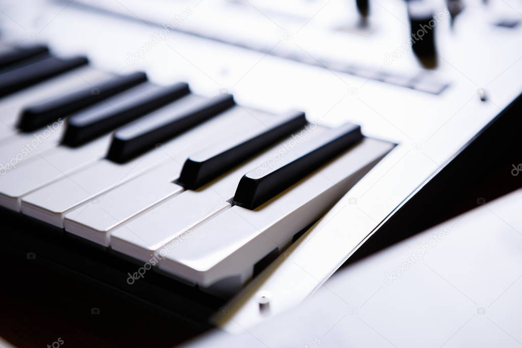Synthesizer key board in close up.Audio equipment for music production.Sound recording studio device for musician & composer.Professional electronic midi keyboard with black and white piano keys