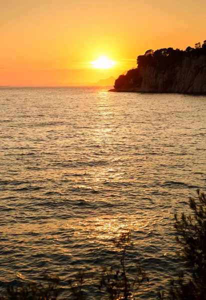 Beautiful seascape view.Sunset sun goes down over the horizon.Vertical landscape.Popular travel destination for summer holidays travel.Enjoy the views and relax in evening sun set