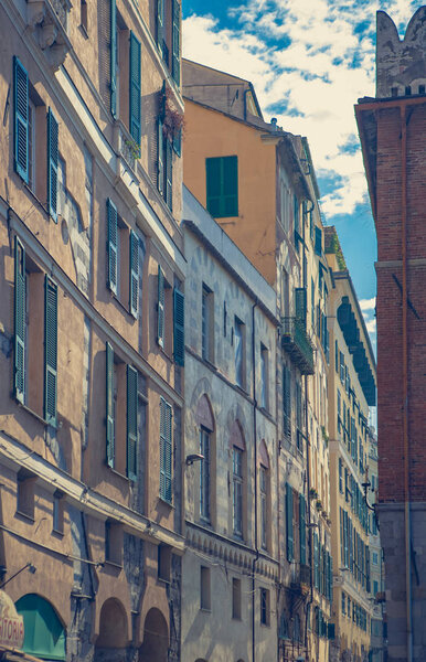 GENOVA,ITALY-12 OCTOBER,2018: Classic Italian houses in Old City Port area of Genoa.Popular travel destination for cultural tourism.Instagram fading film filter.Vintage architecture in Liguria