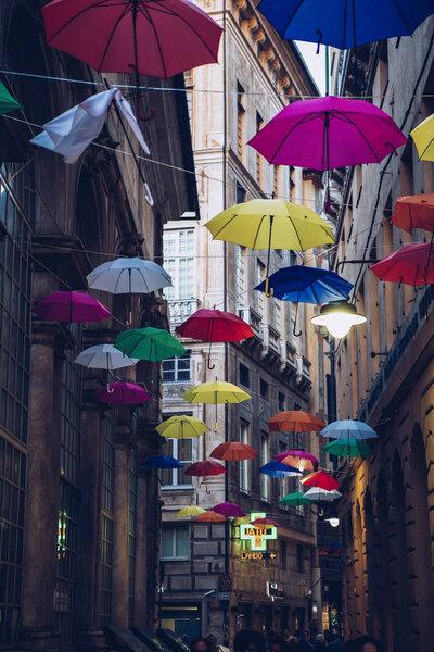 GENOVA,ITALY-12 OCTOBER,2018: Ancient city Genoa street decorated with colorful umbrellas.Popular travel destination for cultural tourism.Instagram vintage film filter