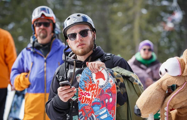 Bukovel 乌克兰 2018年3月 带头盔的骑手肖像 手里拿着木板 雪园冬季行动体育节 年轻人参加大型空中滑雪板比赛 积极的青少年生活方式 — 图库照片