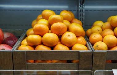 Gıda pazarında satışa turuncu meyve kutusuna yakın. Bakkal meyve departmanında süpermarket satan taze olgun meyveler. Doğal sağlıklı gıda malzemeleri. Satın almak ve vitaminler yemek  