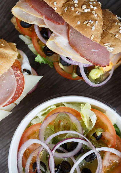 Tasty fresh sandwich in fast food restaurant menu.Delicious snack for lunch.Sliced ham & sausage,cut vegetables,sauce.Natural fastfood dish in cafe menu.Macro,food background