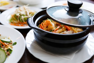 Kase karides sos ve sebze ile kapalı. Egzotik Vietnam yiyecek yemek listesi içinde restoran. Çin restoranı Asya Deniz ürünleri yemek. Yakın çekim, pan kapak sıcak su damla ile odaklanmak