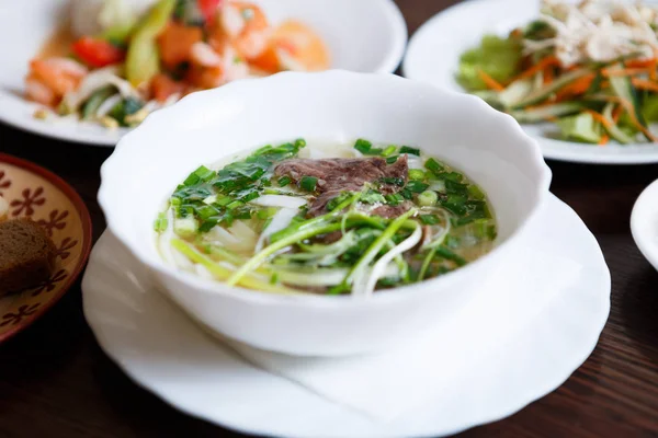 Delicious Vietnamese tradition restaurant food pho bo soup.Natural exotic food menu.Tasty Asian hot dish with beef meat & noodles served in bowl