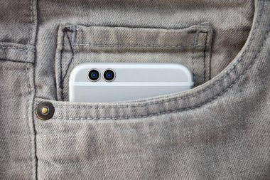  Kot cebinde büyük modern akıllı telefon. Her zaman bağlı kalmak ve harika fotoğraflar çekmek için yeni akıllı telefon satın alın. Odak cep telefonu kamera lensi. Gri pantolon cebinde modern cihaz. Yeni gri akıllı telefon.