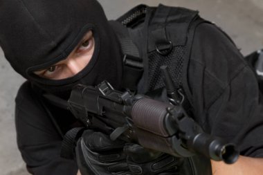 Muharebe Tekdüzen oynayan terörist ya da özel kuvvetler ekibi üyesi olarak silahlı adamın fotoğrafı 