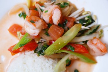 Çin salatası malzemelerin üzerine kapatın. Karides, domates ve baharat haşlanmış kereviz, beyaz plaka üzerinde beyaz Asya pirinç ile devam eder. Gıda makro çekim.