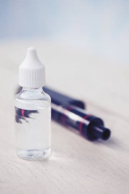 E-çiğ ve e-sıvı vaping için. Lezzetli stok yenileme temel ve modern Buharlaştırıcı aygıt. Sıvı tütün probilen glicol ve gliserin temel ile tekrar doldur. Metin üzerinde şeffaf şişe yerleştirin.