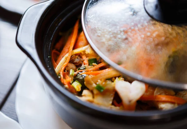 Exotic Vietnamese food close up.Bowl with boiled shrimps in vegetables & rice.Delicious Chinese food composition.Traditional Asian cuisine menu in cafe.Tasty natural seafood dish with open cover