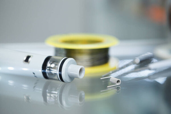 Vape shop.Modern vaping development service & upgrade parts in close up.Buy ualr ecig vaper device.Ic gadget for smoking ejuice.Box mod & wire
