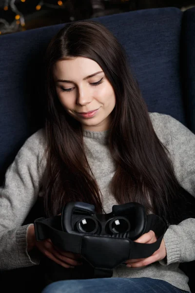 Studio portrait of pretty girl with popular new vr glasses for mobile gaming app.Use virtual reality headset on the go.Innovative mobile gamer gadget.Buy trendy device to play virtual reality games