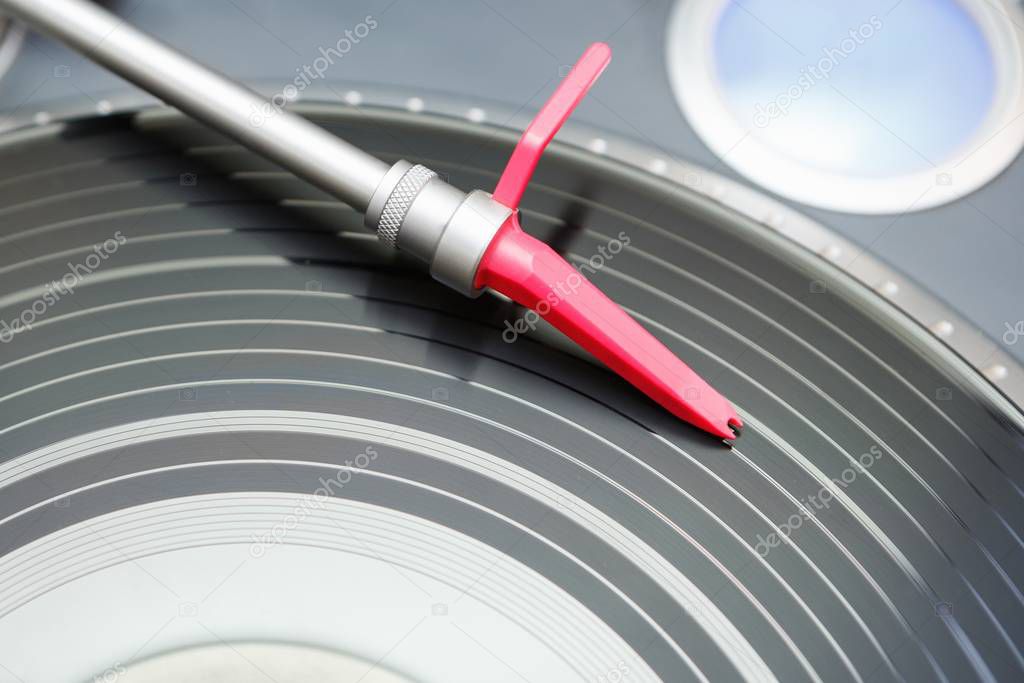 Vintage dj turntable to play music on vinyl audio disc.Hifi audiophile turn table device.Dj audio equipment.Disc jockey turntables close up.Player needle on vinyl record