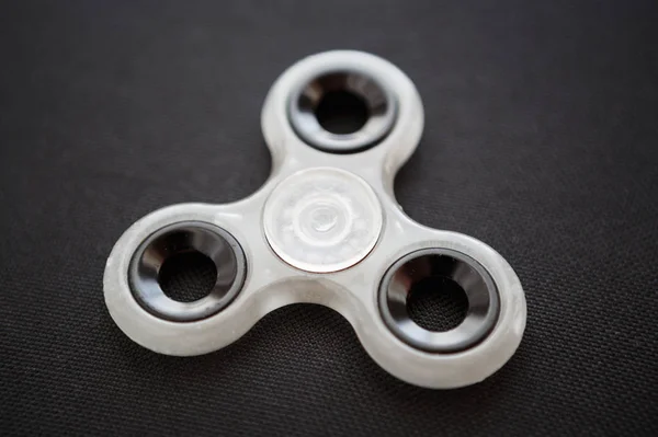 Finger spinner toy on bearings.Super popular spinning device.Enjoy playing with fidget spinners.Cool plastic rotating gadget for fun.Cool mechanical balancing game