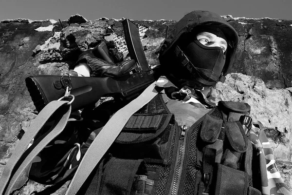 Armed officer in full ammunition holding rifle on his shoulder