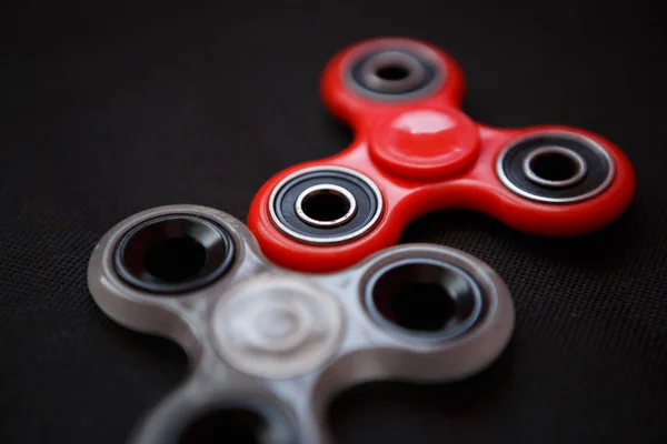 Finger spinner toy on bearings.Super popular spinning device.Enjoy playing with fidget spinners.Cool plastic rotating gadget for fun.Cool mechanical balancing game