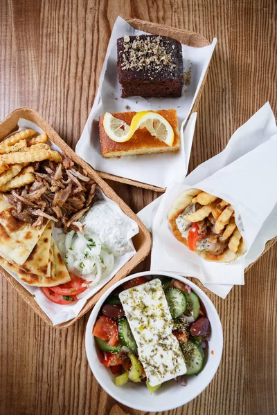 Enjoy tasty meat fast food menu in Greek restaurant.Delicious fat junk food served in take away paper plate in snack cafe.Traditional Greek cuisine snacks,unhealthy eating menu