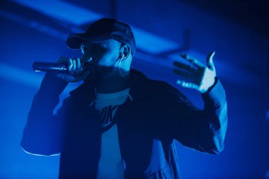 Kiev-11 Ağustos,2018: Rap şarkıcısı Ligalize açık hava gece kulübünde Kurazh yaz müzik festivali sahnede mikrofonda şarkı söylüyor. Dövmeli beyaz rapçi sahnede mikrofonda şarkı lar. Hip hop yıldız performansı