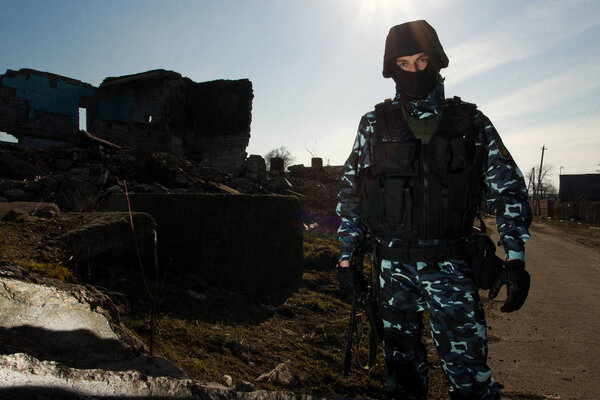 Armed officer in full combat ammunition on guard