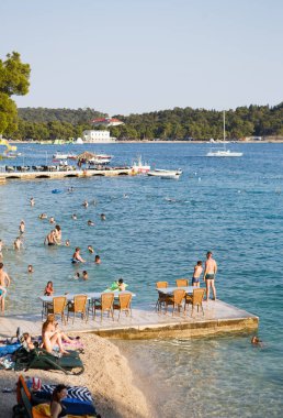 Makarska, Hırvatistan - 23 Haziran, 2017: iyi yaz günü turist ile Halk Plajı. Güzel mavi su yüzme için. Popüler seyahat hedef