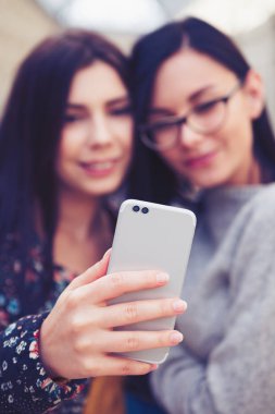 Selfie Çift objektifli fotoğraf makinesi telefon ile alıyor. Modern smartphone kadın elinde iki lens ile. Yeni mobil gadget ile selfy alarak kız.