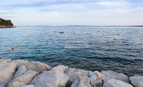 Water polo sports ground in Croatia.Gates flot on water surface at Adriatic Sea coast.Fun summer sport acitivity for tourists and athletes.