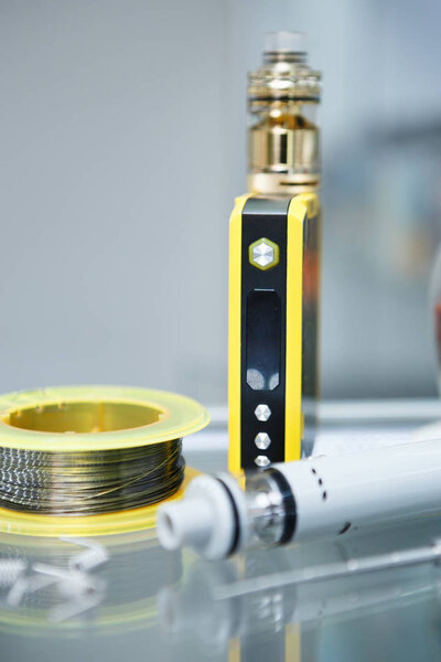 Vape shop.Modern vaping device maintenance & upgrade parts in close up.Buy popualr ecig vaper device.Electronic cigarette gadget for smoking ejuice.Box mod & wire