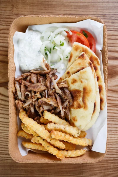 Enjoy tasty meat fast food menu in Greek restaurant.Delicious fat junk food served in take away paper plate in snack cafe.Traditional Greek cuisine snacks,unhealthy eating menu