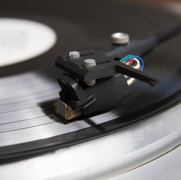 Turntable player with musical vinyl record. retro theme.