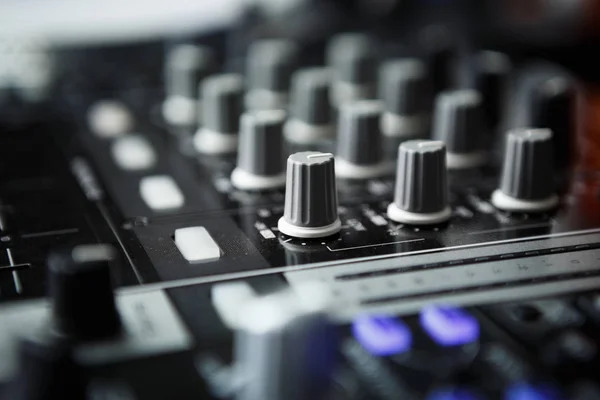 Professional party dj sound mixer controller.Focus on faders & volume regulators.Play & remix music tracks at party or concert with modern audio equipment.Sound effector close up