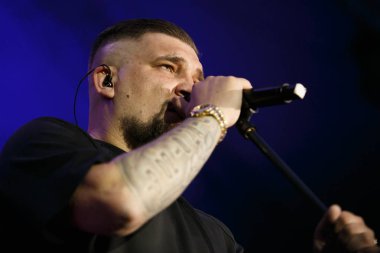 MOSCOW - 21 JULY,2017: Rap singer Basta performing live set on Gazgolder Live music festival outdoor.Open air entertainment event.Popular rapper with microphone on stage clipart